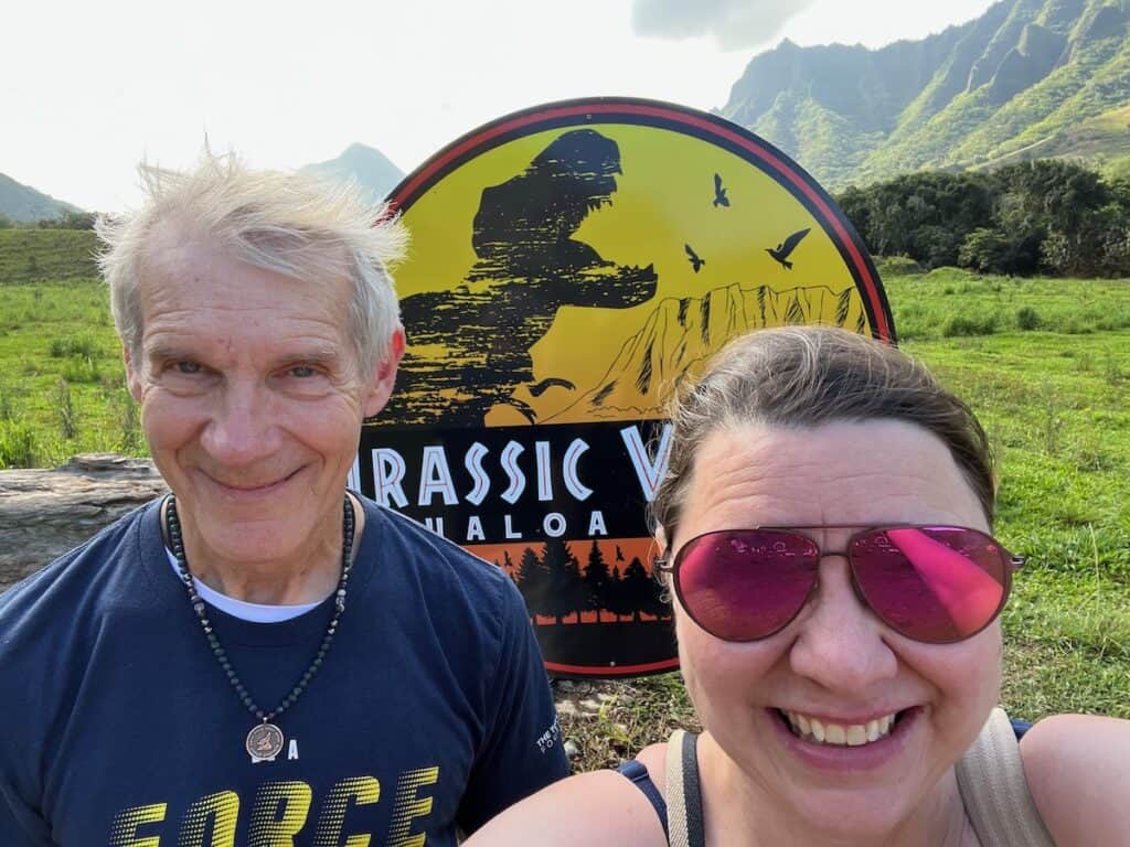 two tourist at the Juarassic Park Sign