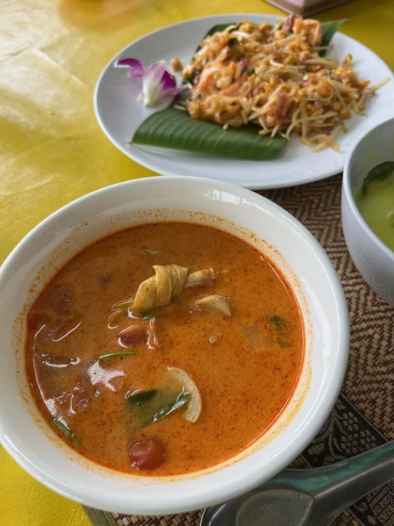 Tom Yom Soup with Pad Thai in the backgroud