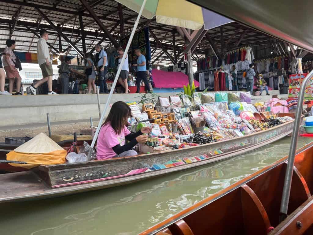 Woman in boat at floating maket in Damnoen Saduak Floating Marke