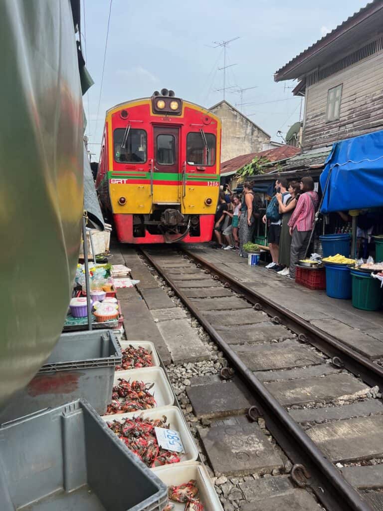 Train entering the maeklong Railway Market