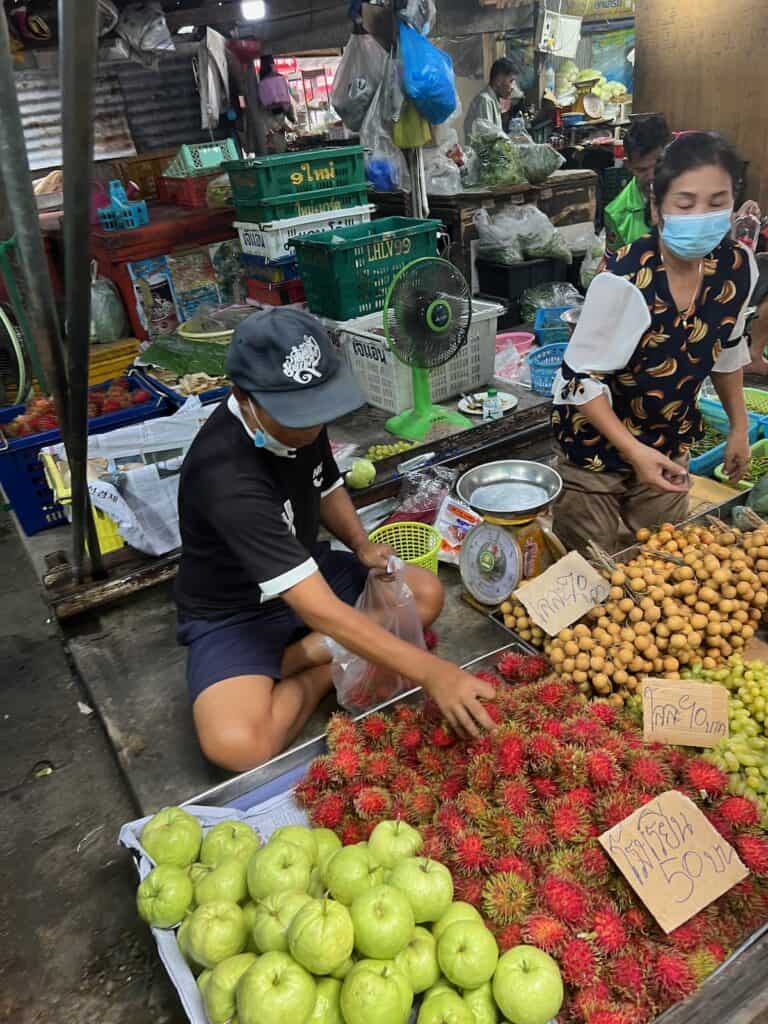 Vendor along the traks at the maeklong Railway market
