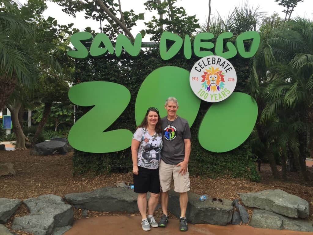 Me and my husband in front of a San Diego Zoo sign