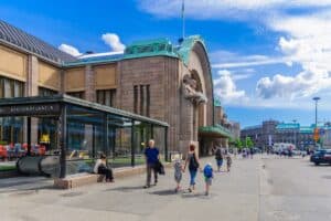 View of the Central railway station, with locals and visitors, in Helsinki, Finland