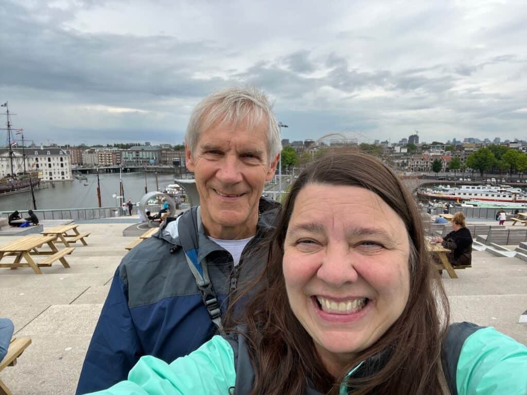 My husband and me at the top of the NEMO Science Museum with Amsterdam in the background.