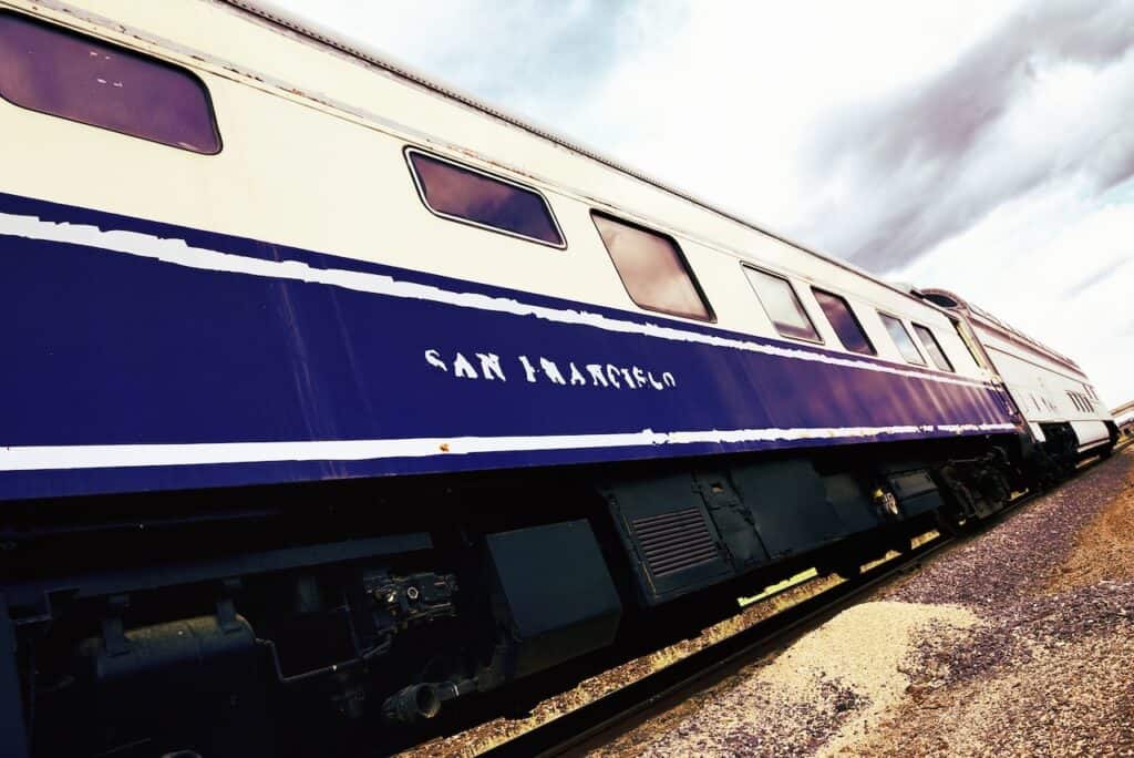Vintage Steam engine train down railroad track towards camera. San francisco writted on front vintage spirit
