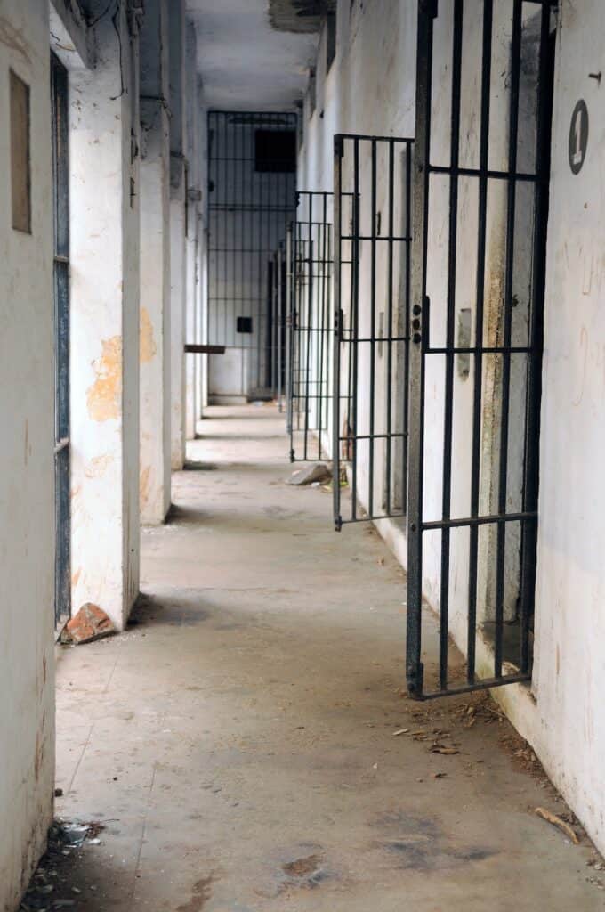 hallway to jail cells with open doors