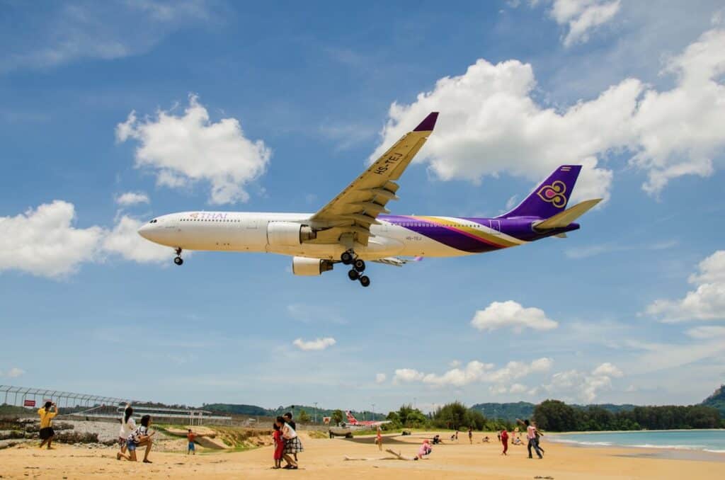 Thai Airways airplane landing at Phuket International airport, runway near the beach, Phuket, Thailand.