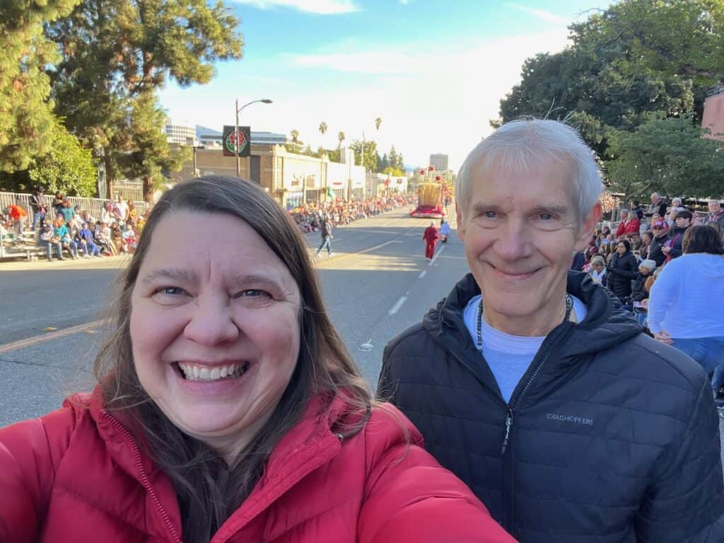 Me and my husband with the Rose Parade moving off in the background