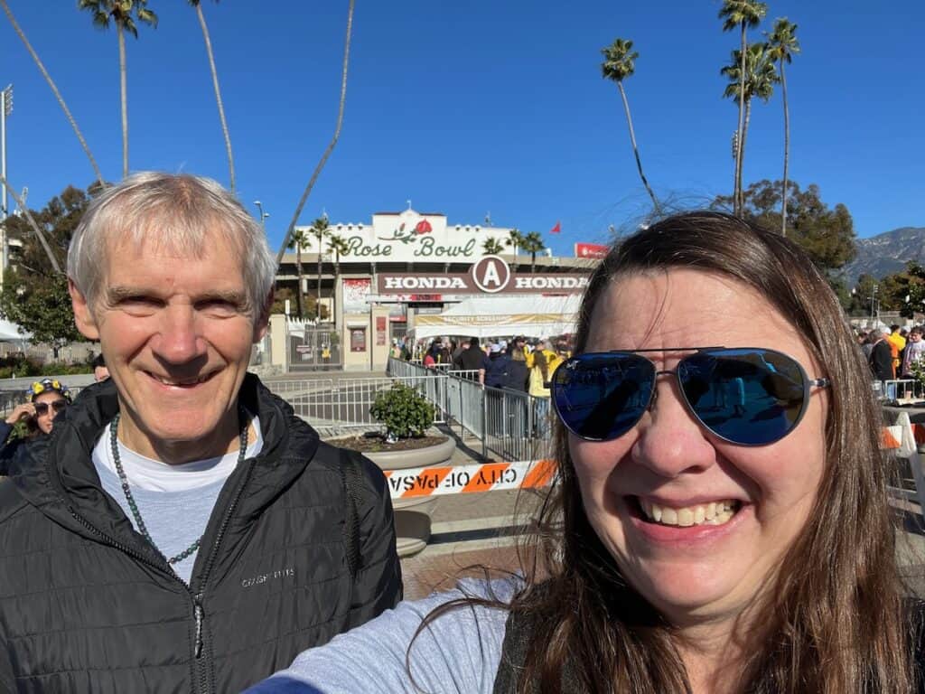 my husband and I standing in front of the iconic Rose Bowl before the football game