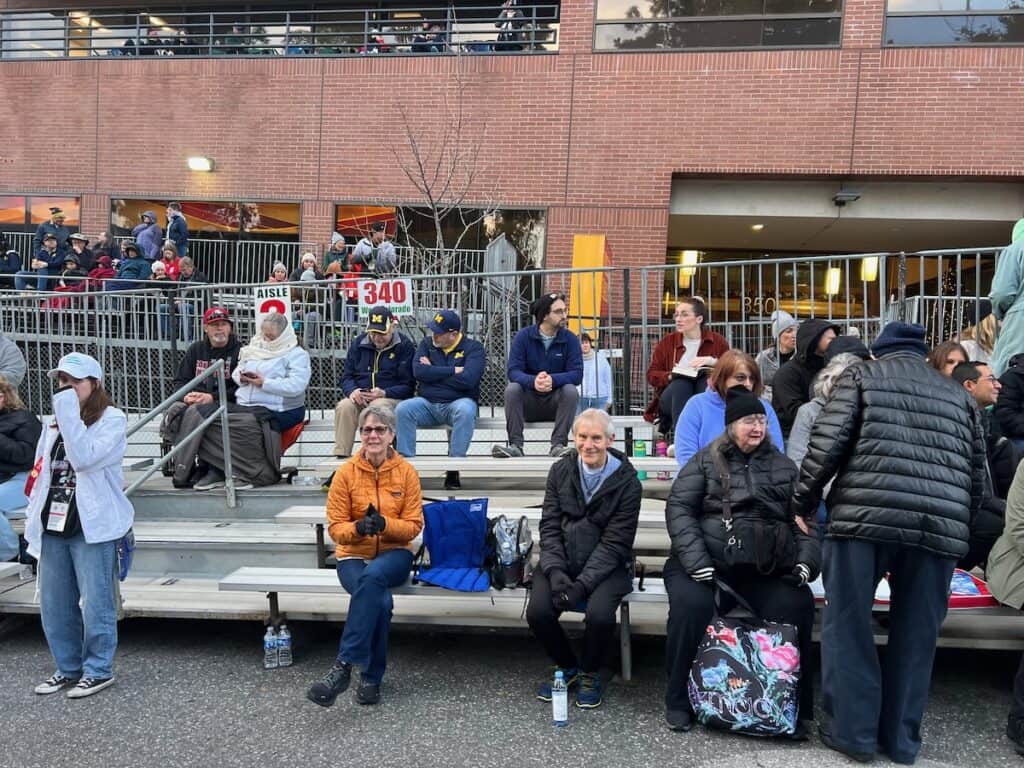 My husband and others sitting in the grand stands waiting on the rose parade to start