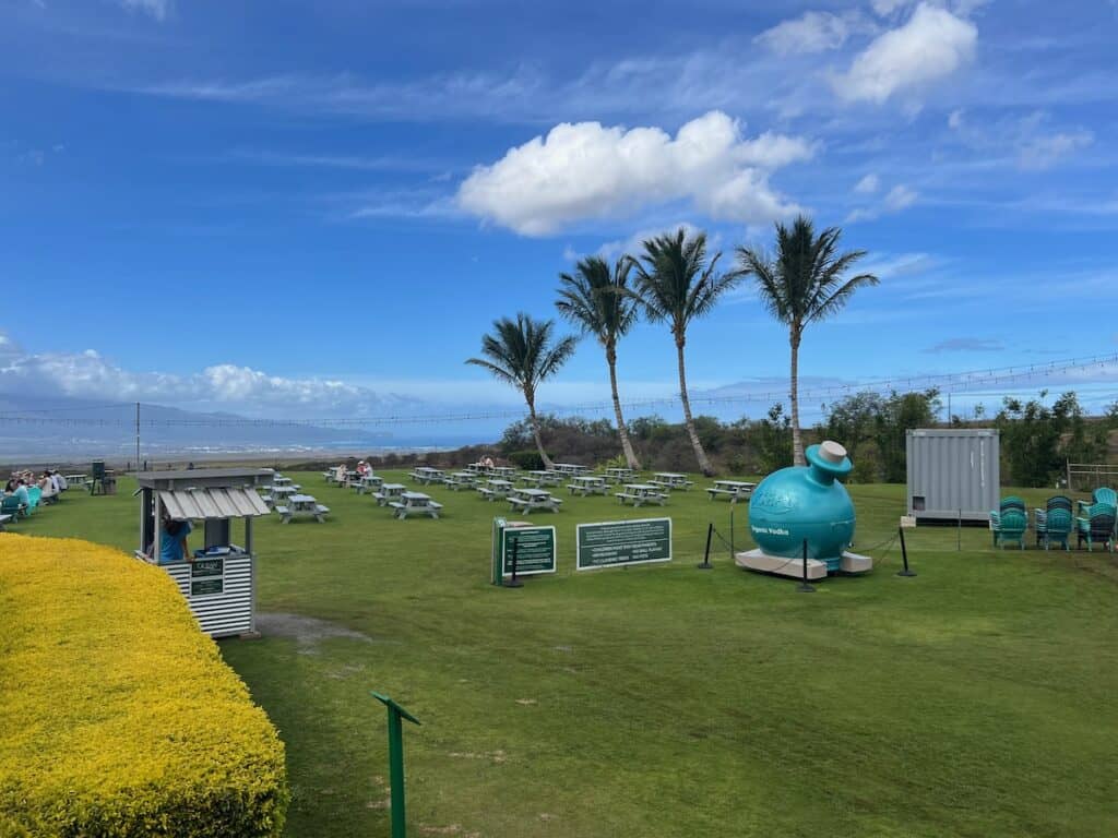 View of outdoor seating and overlook of the ocean at Ocean Vodka Distillary on Maui