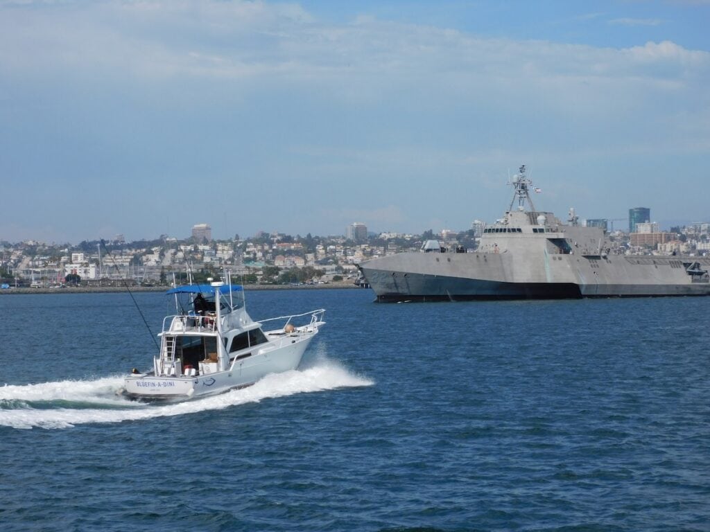 Naval Ship and Fishing Boat in the San Diego Harbor with San Diego shoreline in the background