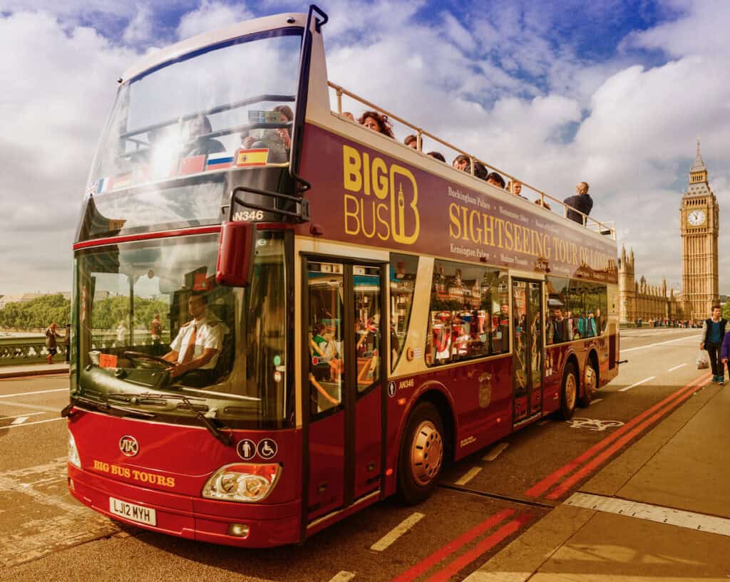 Big Bus Hop On Hop of Tour Bus with Big Ben in the background