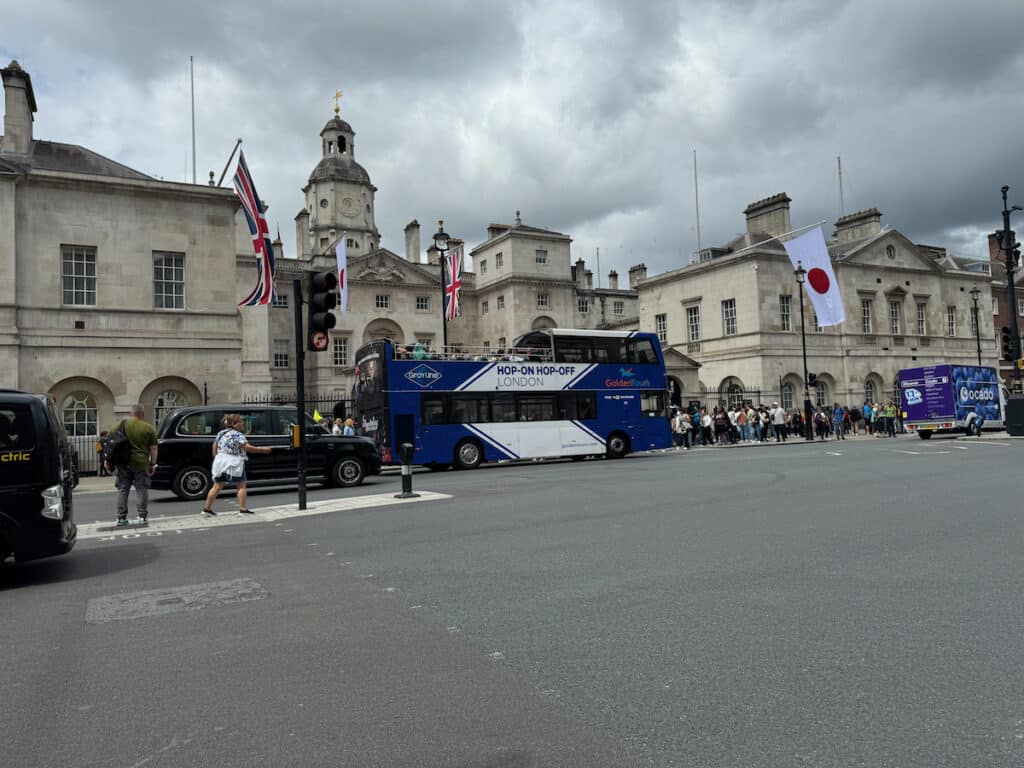 Golden Tour Greyline Hop on Hop off Blue and white double decker bus in front of the Japan Embassy in London