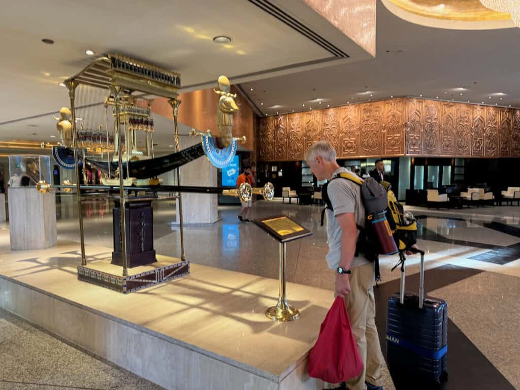 Man looking at Egyptian decorations in the lobby of the Hilton Cairo