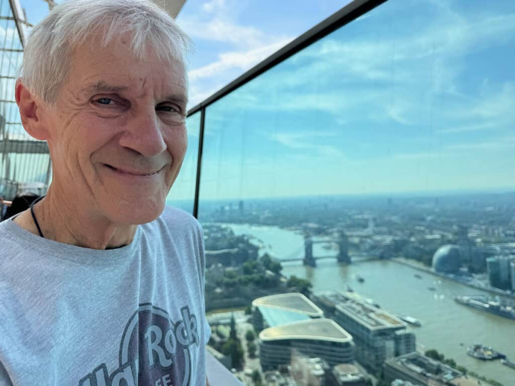 My husband with the Tower of London Bridge behind him on the outside Terrace of the Sky Garden