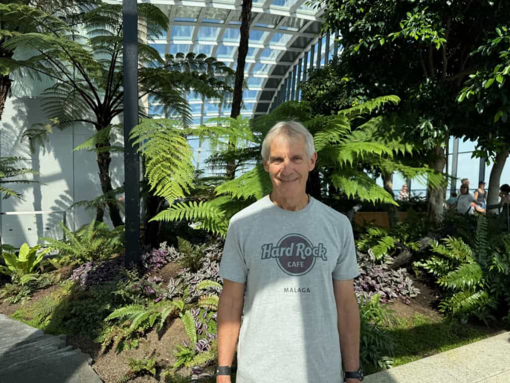 My husband in front of a garden area in the sky garden London