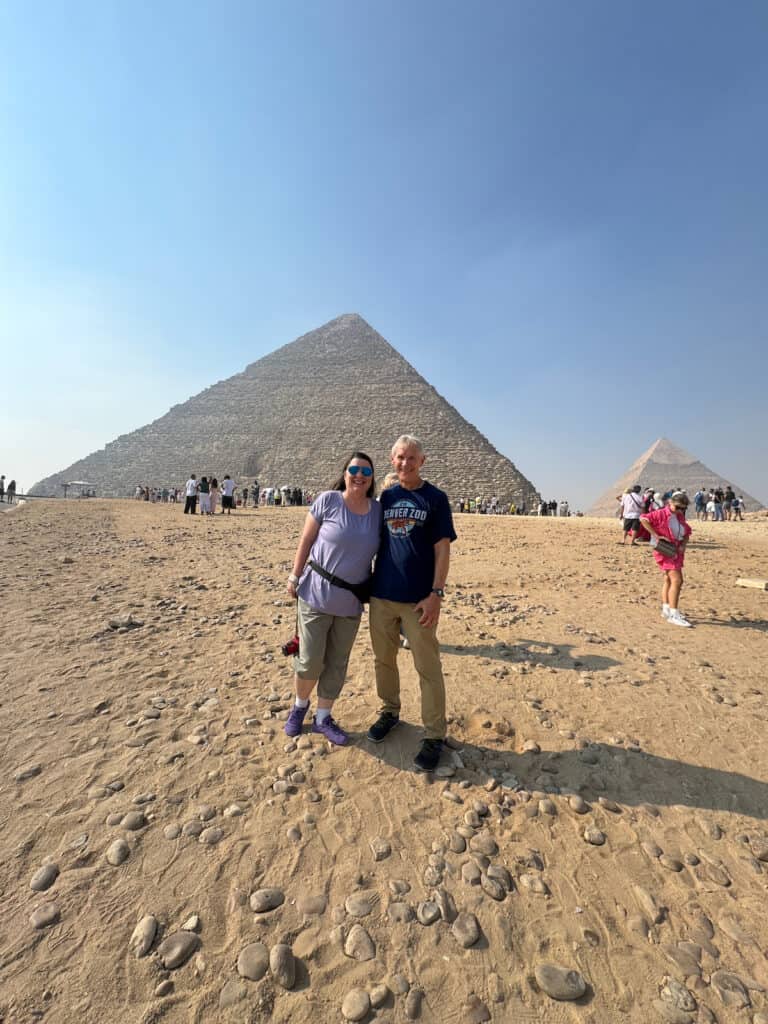 My husband and I standing in front of two of the Pyramids in Cairo Egypt