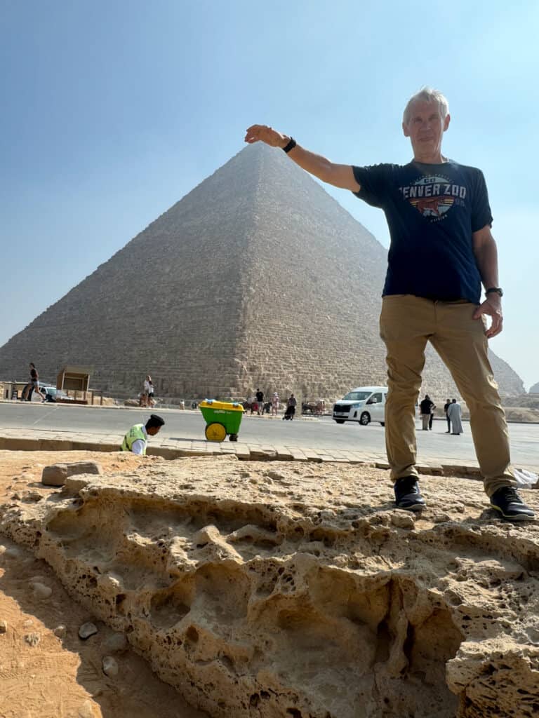 My husband touching the top of a pyramid in Egypt