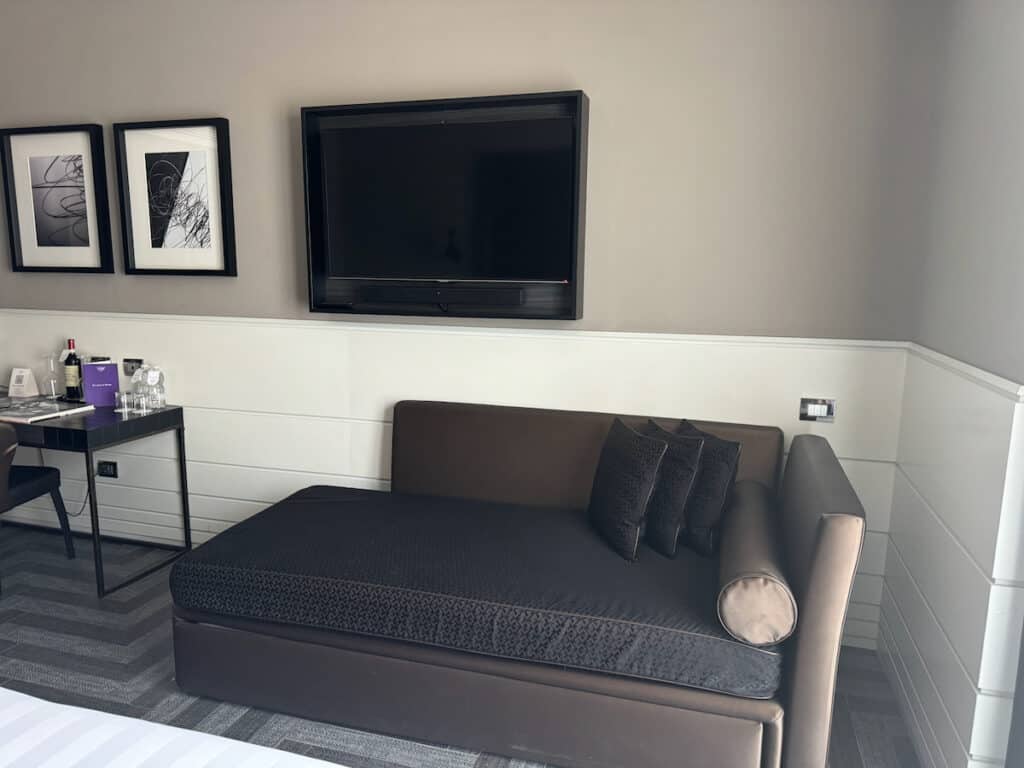 Sofa and TV in our room at the Tribune in Rome