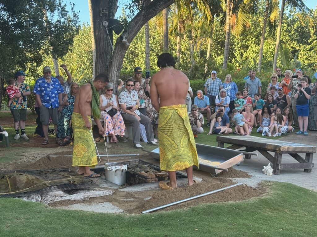 Pulling the pig up from the ground at the luau