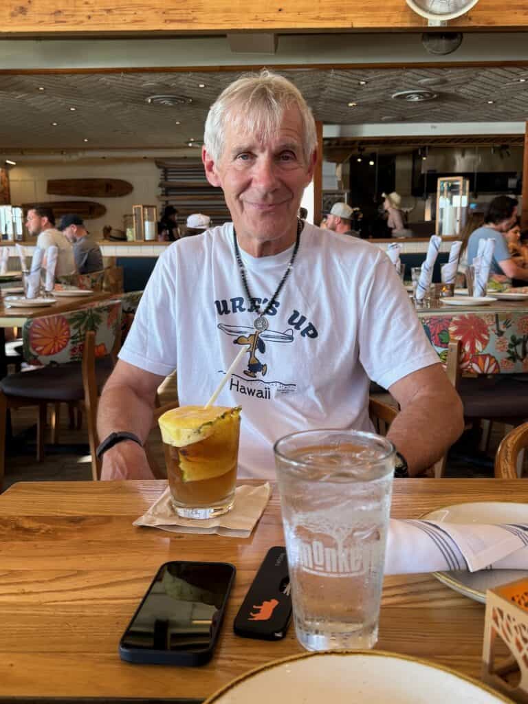 My husband with. his mai tai at monkeypod kitchen maui
