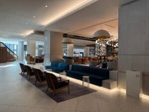 View of seating area in the Hilton Quebec City lobby with the restaurant in the backgound