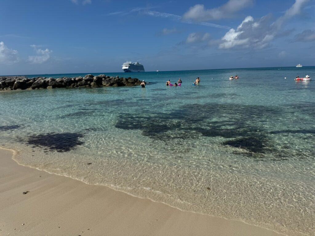 Clear beach with people swimming and snorkeling on Princess Cay