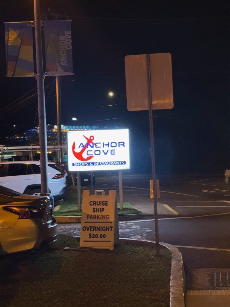 Anchor Cove shopping mall with the Curise ship parking sign and the NCL Pride of America in the background