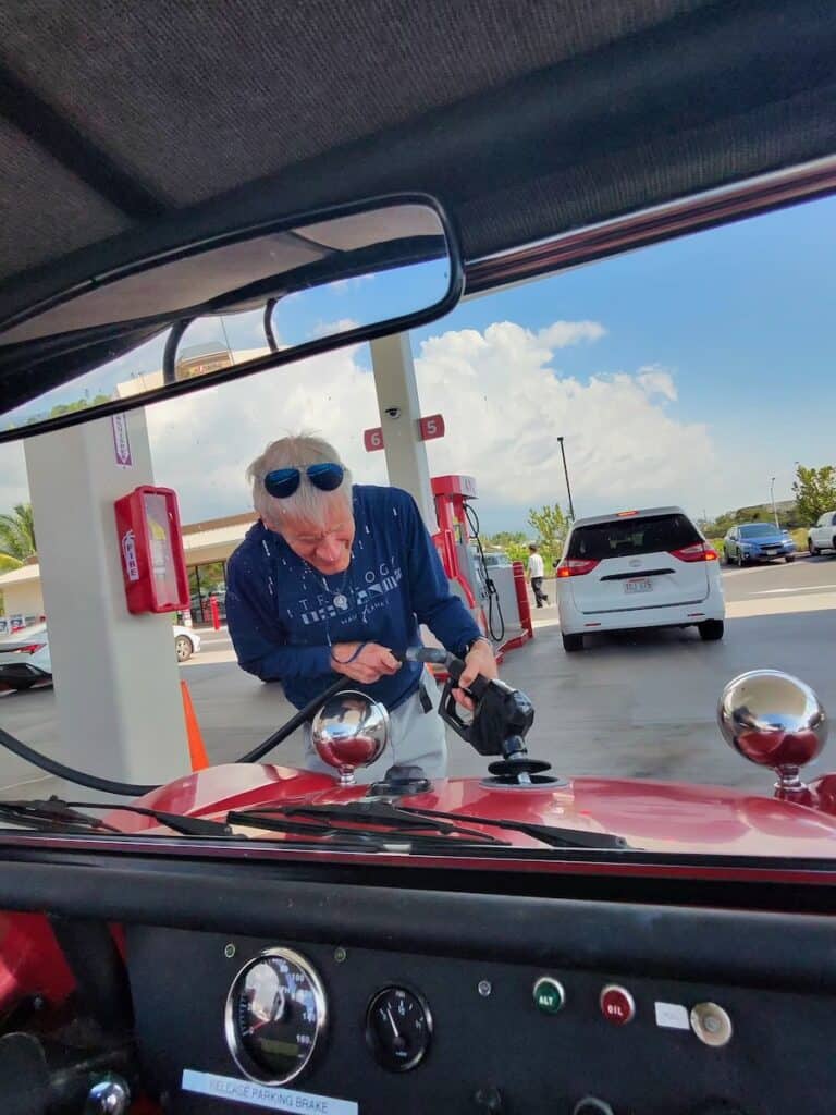 My husband filling the gas tank of our Big Island Buggy